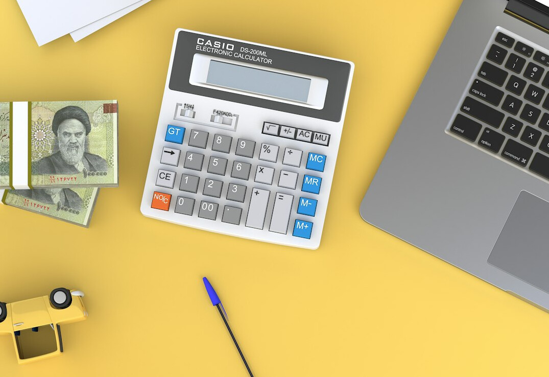 person using loan calculator on laptop