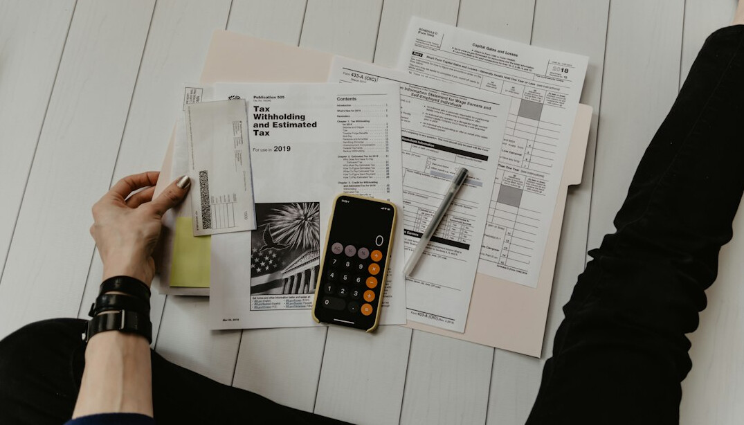 person budgeting with calculator