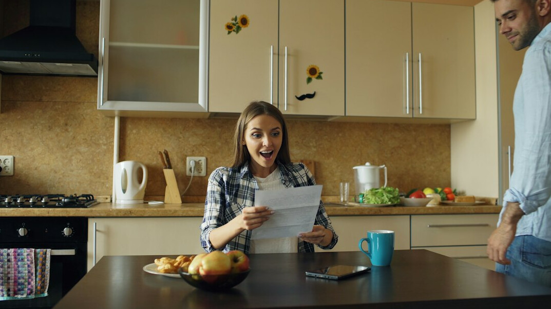 family discussing money at kitchen table
