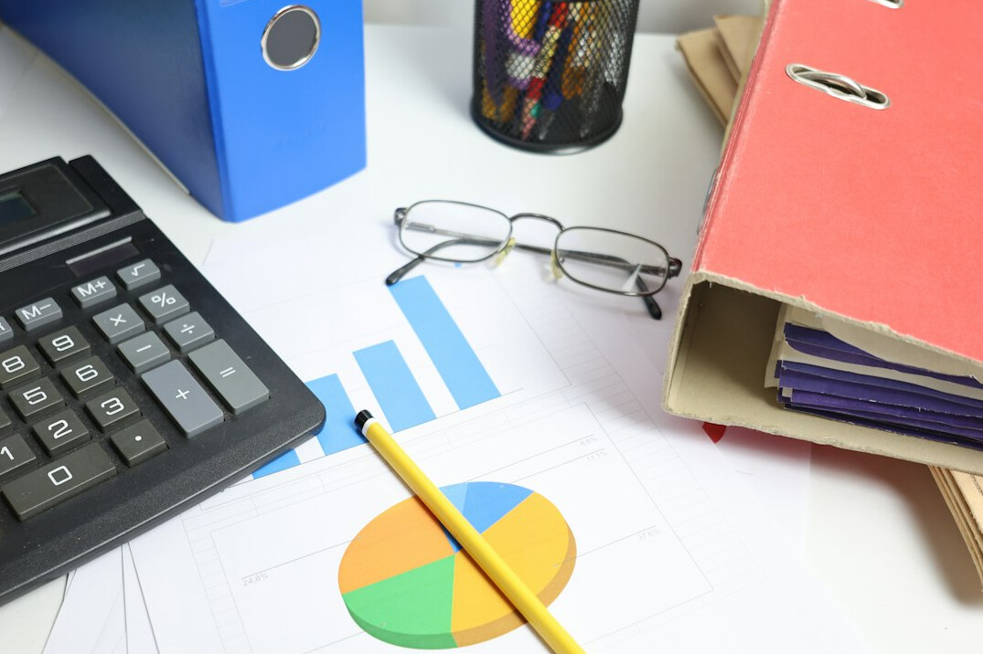 calculator on desk with charts